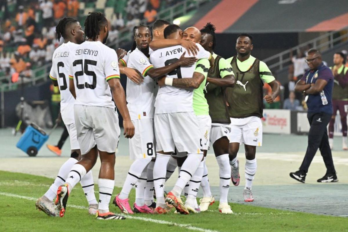Ghana's forward #9 Jordan Ayew celebrates with teammates after scoring his team's first goal during the Africa Cup of Nations (CAN) 2024 group B football match between Mozambique and Ghana at Alassane Ouattara Olympic Stadium in Ebimpe, Abidjan on January 22, 2024.  Issouf SANOGO / AFP