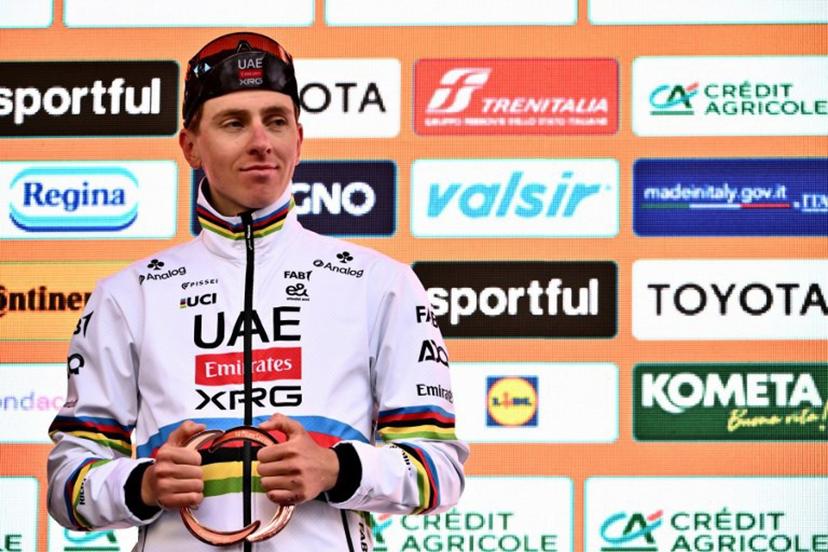 Team UAE's Slovenian rider Tadej Pogacar, third, celebrates during the podium ceremony of the Milan - Sanremo one-day classic cycling race, on March 22, 2025. Dutch Mathieu Van Der Poel of team Alpecin-Deceuninck won the race ahead of Team Ineos' Italian rider Filippo Ganna and Team UAE's Slovenian rider Tadej Pogacar, third.  Marco BERTORELLO / AFP