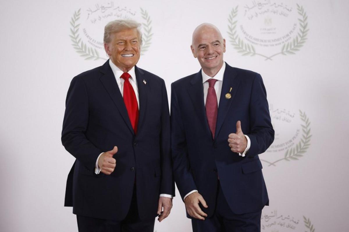 FIFA President Gianni Infantino (R) and US President Donald Trump pose during a summit on Gaza in Sharm el-Sheikh on October 13, 2025. Trump landed in Egypt on October 13 for a summit on Gaza, following a lightning visit to Israel after a ceasefire he brokered entered into force Yoan VALAT / POOL / AFP
