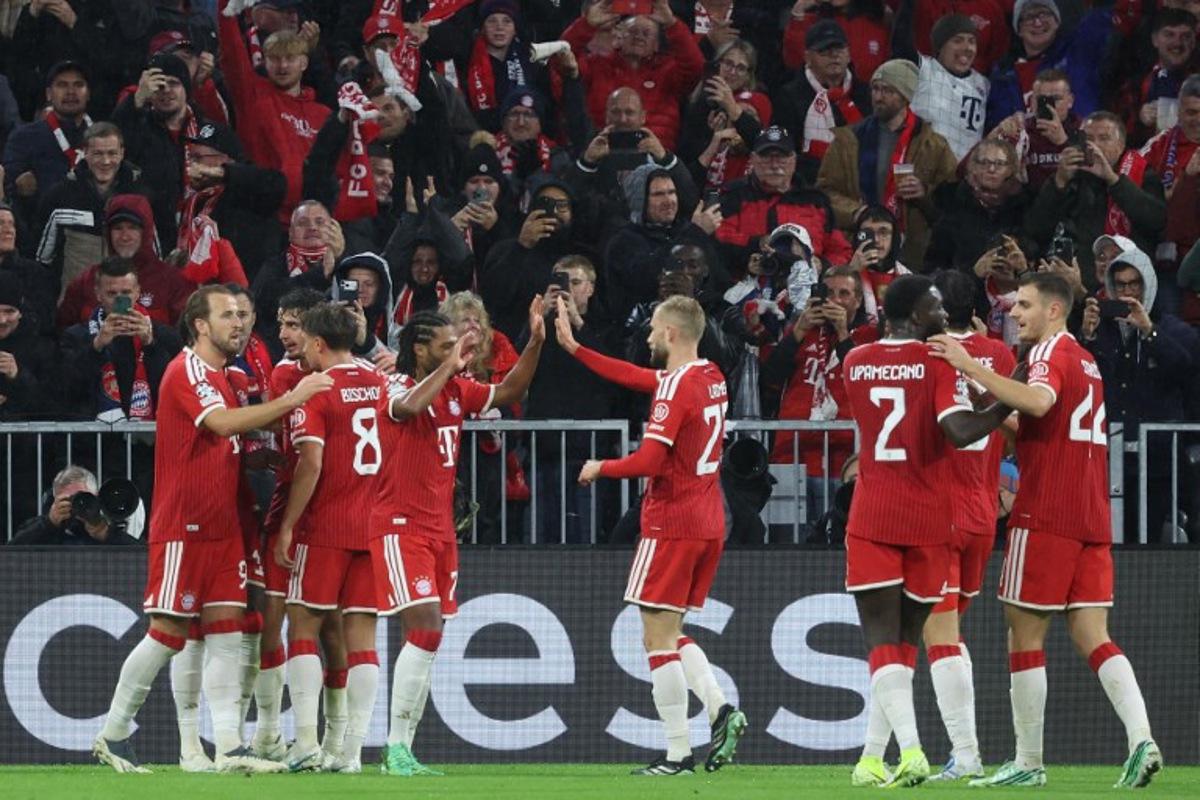Bayern Munich's Canadian defender #19 Alphonso Davies (hidden) celebrates scoring the 1-1 goal with his teammates during the UEFA Champions League football match between FC Bayern Munich and Arsenal FC in Munich, southern Germany on October 21, 2026.  Karl-Josef HILDENBRAND / AFP