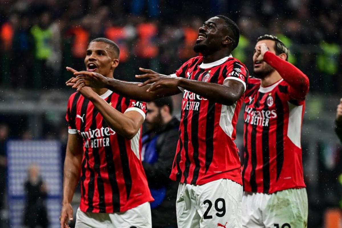 AC Milan's French midfielder #29 Youssouf Fofana celebrates with teammates after their win at the end of the Coppa Italia second leg semi-final football match between Inter Milan and AC Milan at the San Siro stadium in Milan on April 23, 2025.    Piero CRUCIATTI / AFP