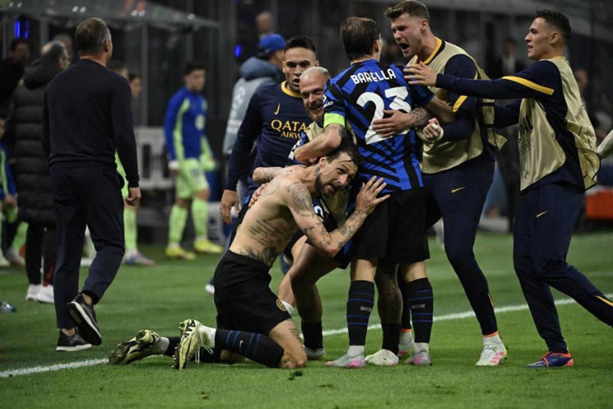 Inter Milan's Italian defender #15 Francesco Acerbi celebrates scoring his team's third goal with teammates during the UEFA Champions League semi-final second leg football match between Inter Milan and FC Barcelona at the San Siro stadium in Milan on May 6, 2025.  PIERO CRUCIATTI / AFP