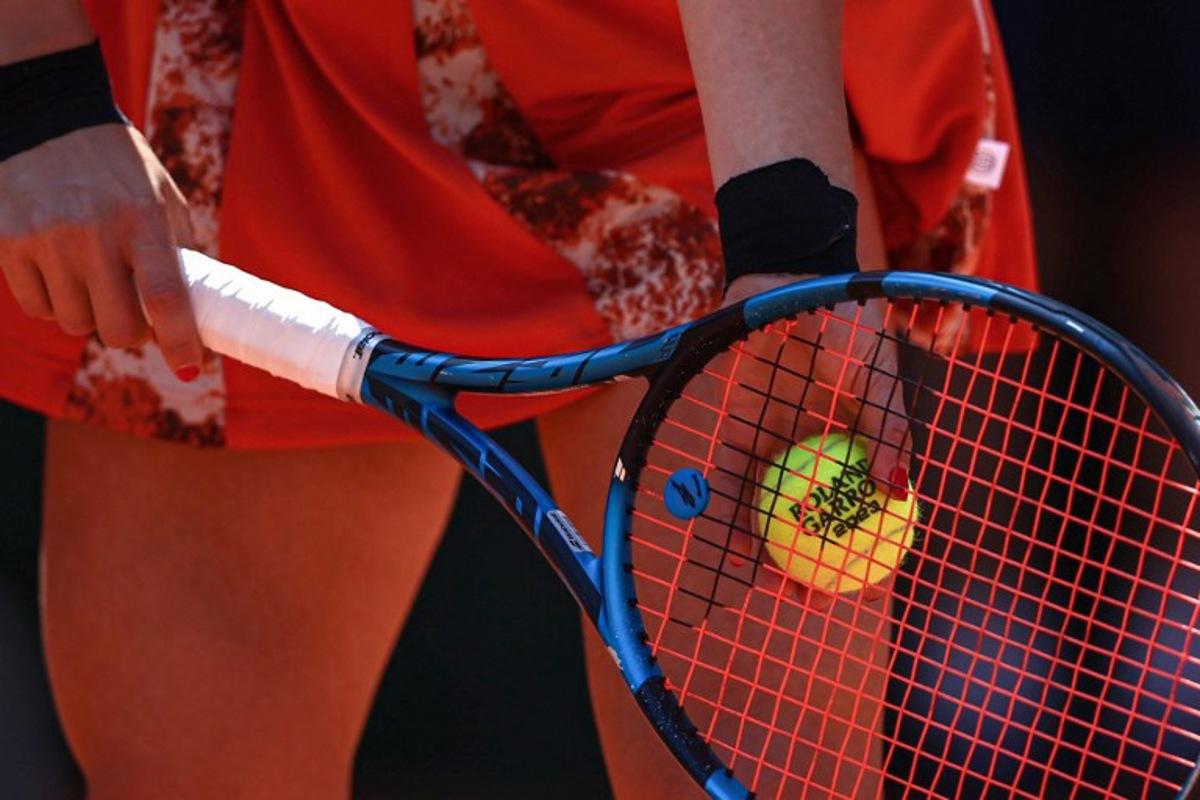 Russia's Elina Avanesyan holds a ball as she plays against Switzerland's Belinda Bencic during their women's singles match on day two of the Roland-Garros Open tennis tournament at the Court Suzanne-Lenglen in Paris on May 29, 2023.  Anne-Christine POUJOULAT / AFP