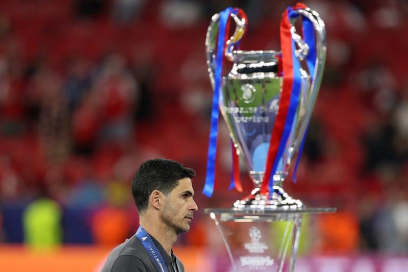 Arsenal's Spanish manager Mikel Arteta walks past the trophy following the UEFA Champions League final football match between Paris Saint-Germain (PSG) and Arsenal FC at the Puskas Arena in Budapest on May 30, 2026.   Odd ANDERSEN / AFP
