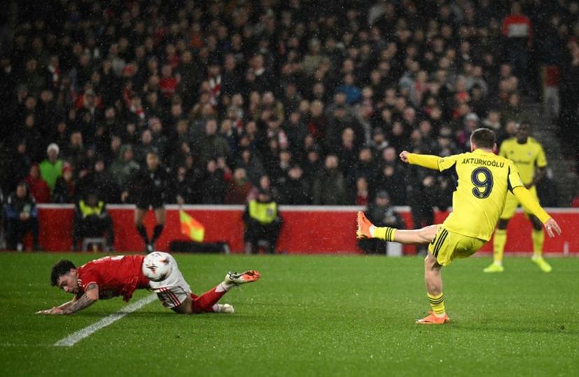 Fenerbahce's Turkish striker #09 Muhammed Kerem Akturkoglu shoots past Nottingham Forest's Welsh defender #03 Neco Williams to score the opening goal during the UEFA Europa League Knockout Round Play-off second-leg football match between Nottingham Forest and Fenerbahce SK at The City Ground in Nottingham, central England, on February 26, 2026.  Oli SCARFF / AFP