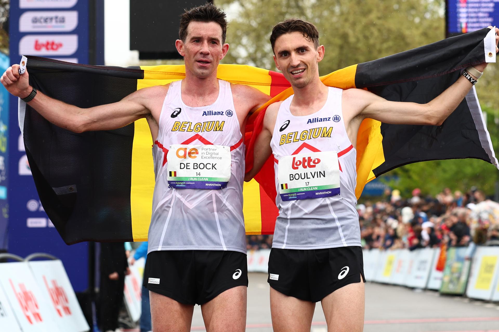 Belgian Thomas De Bock and Belgian Dorian Boulvin pictured at the arrival with a Belgian flag at the men marathon race at European Running Championships, from Leuven to Brussels, Sunday 13 April 2025. BELGA PHOTO DAVID PINTENS