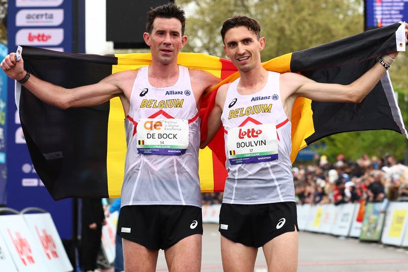 Belgian Thomas De Bock and Belgian Dorian Boulvin pictured at the arrival with a Belgian flag at the men marathon race at European Running Championships, from Leuven to Brussels, Sunday 13 April 2025. BELGA PHOTO DAVID PINTENS