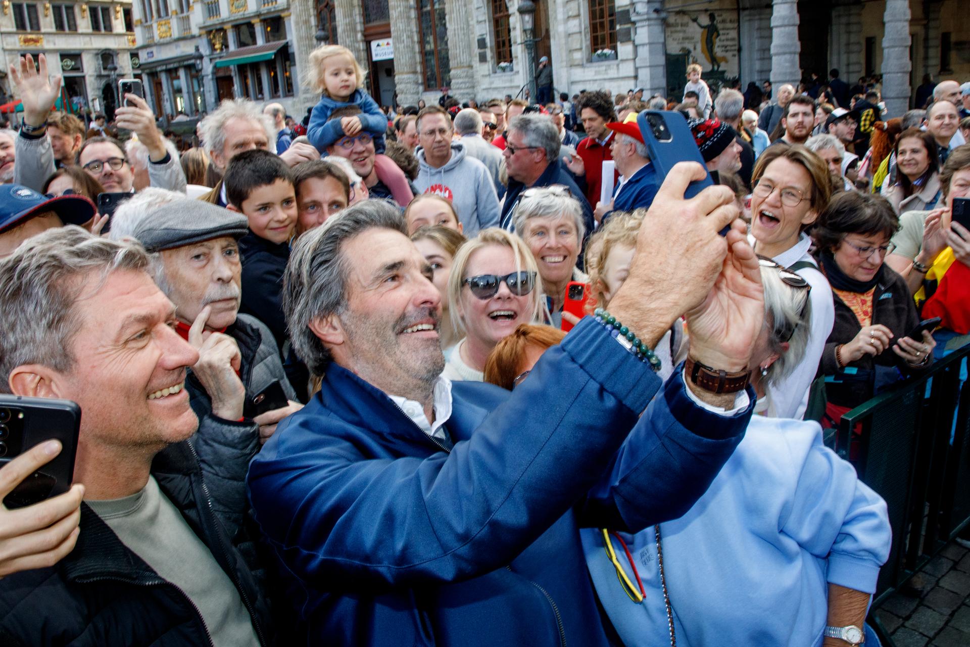 Belgian sailor Denis Van Weynbergh poses with fans during celebrations at the Grand Place - Grote Markt square in the city center of Brussels, for Van Weynbergh who completed the 'Vendee Globe' race, Saturday 22 March 2025. The 2024-2025 Vendee Globe was a non-stop round the world yacht race crewed by only one person, Belgian Van Weynbergh completed the race but finished after the official deadline. BELGA PHOTO HATIM KAGHAT