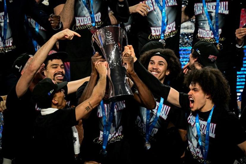 Paris' team celebrates with the trophy on the podium after winning the Eurocup second leg basketball match between JL Bourg (Bourg-en-Bresse) and Paris basketball at the Ekinox arena in Bourg-en-Bresse, central eastern, on April 12, 2024.  OLIVIER CHASSIGNOLE / AFP