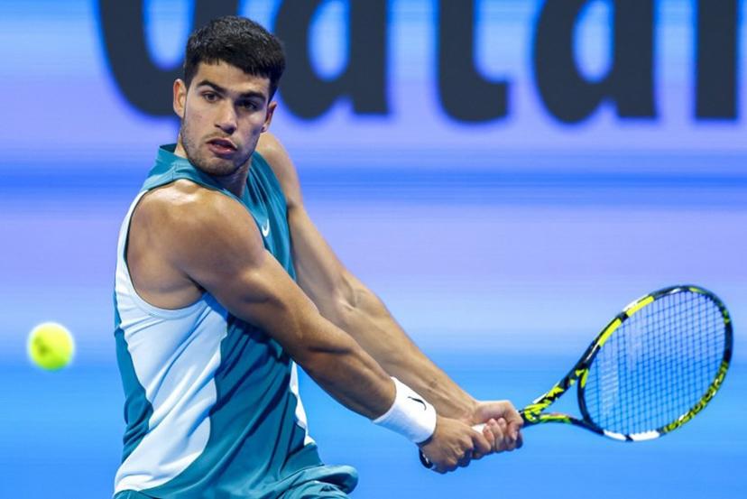 Spain's Carlos Alcaraz hits a return to Italy's Luca Nardi during their men's singles match at the ATP Qatar Open tennis tournament in Doha on February 19, 2025.  KARIM JAAFAR / AFP