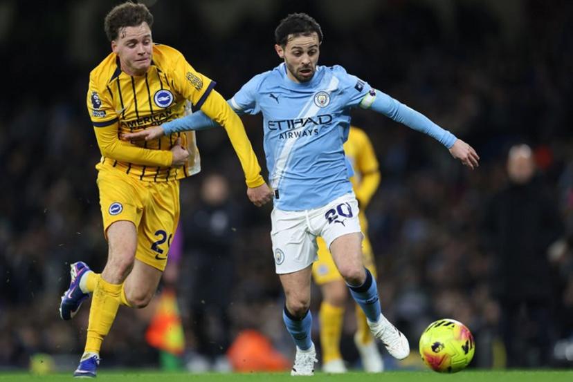 Manchester City's Portuguese midfielder #20 Bernardo Silva (R) takes on Brighton's Belgian defender #29 Maxim De Cuyper (L) during the English Premier League football match between Manchester City and Brighton and Hove Albion at the Etihad Stadium in Manchester, north west England, on January 7, 2026.  Darren Staples / AFP
