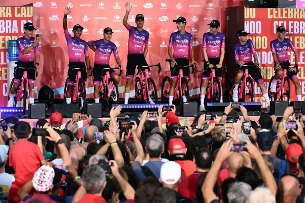 Team Burgos-Burpellet-BH riders wave during the official teams presentation of the 80th edition of 'La Vuelta' cycling tour of Spain, in Torino, Italy on August 21, 2025.  Marco BERTORELLO / AFP