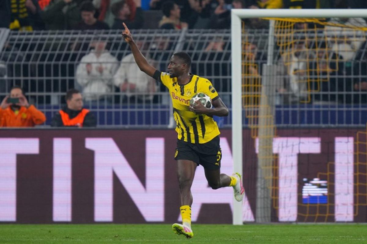 Dortmund's Guinean forward #09 Serhou Guirassy celebrates scoring the opening goal from the penalty spot during the UEFA Champions League quarter-final second leg football match between BVB Borussia Dortmund and FC Barcelona in Dortmund, western Germany on April 15, 2025.  Pau BARRENA / AFP
