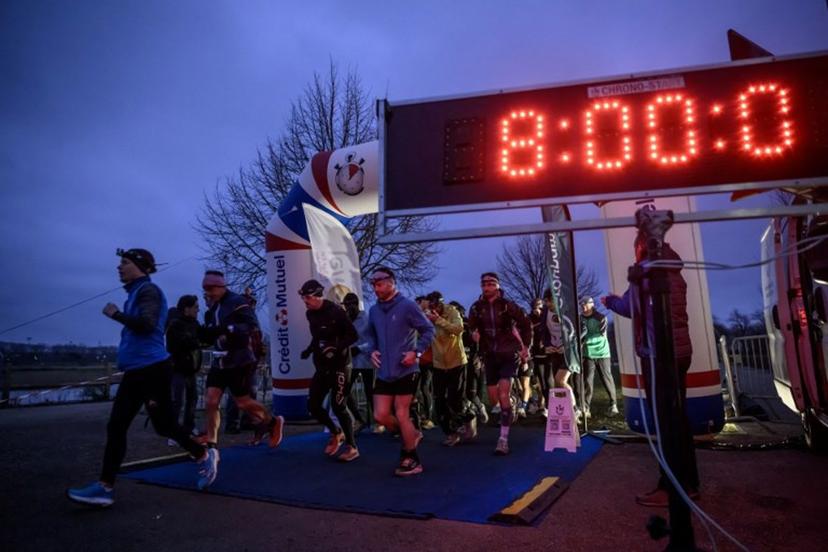 Remaining competitors set off during an ultra-endurance 'Backyard' race in Castanet-Tolosan near Toulouse early on January 25, 2025. 'Backyard' races involves a 6.7km loop which must be completed in less than one hour as many times as possible until there is only one runner left, who is then declared the winner. Ed JONES / AFP