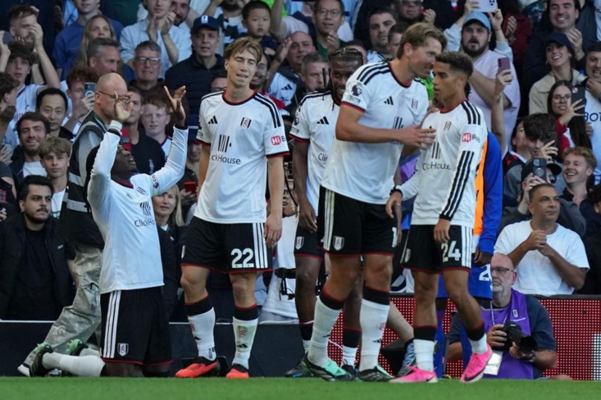 Fulham's players celebrate their first goal, an own-goal scored by Manchester United's Argentinian defender #06 Lisandro Martinez during the English Premier League football match between Fulham and Manchester United at Craven Cottage in London on September 20, 2026.  CARLOS JASSO / AFP
