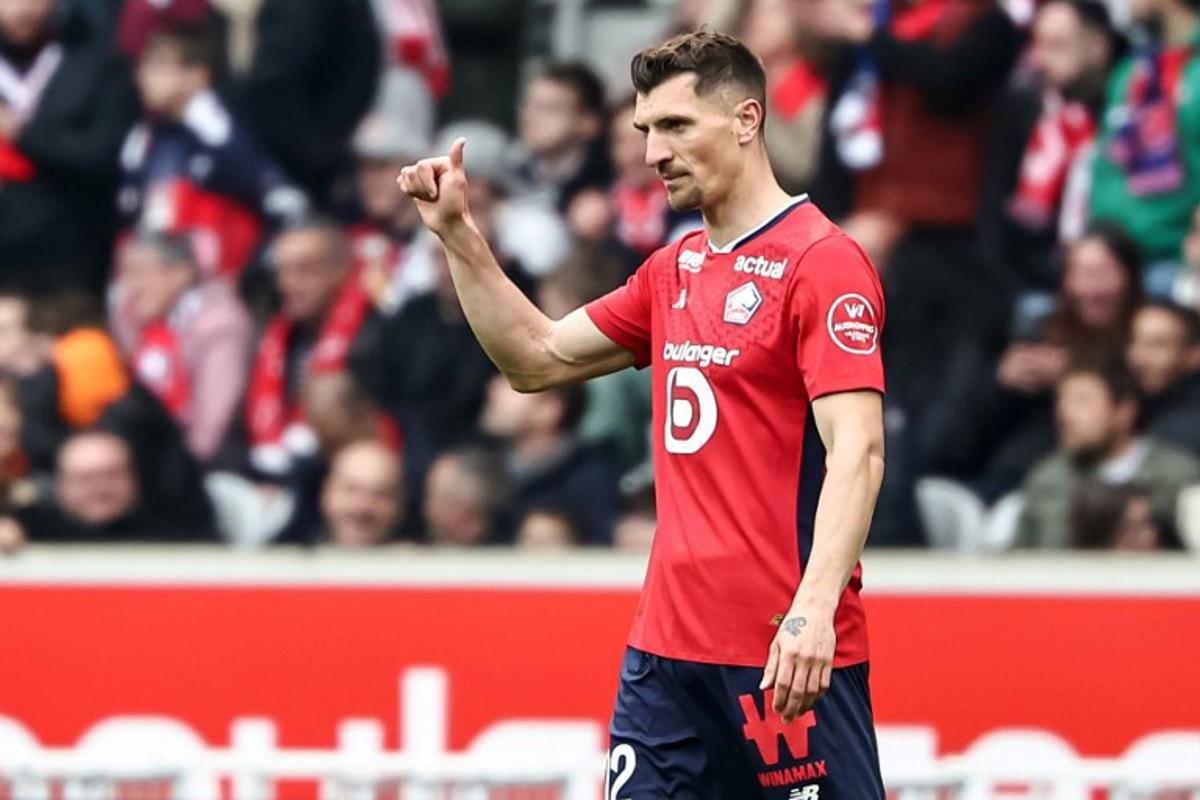 Lille's Belgian defender #12 Thomas Meunier celebrates after scoring his team's opening goal during the French L1 football match between Lille LOSC and AJ Auxerre at Stade Pierre-Mauroy in Villeneuve-d'Ascq, northern France on April 20, 2025.  Sameer Al-DOUMY / AFP