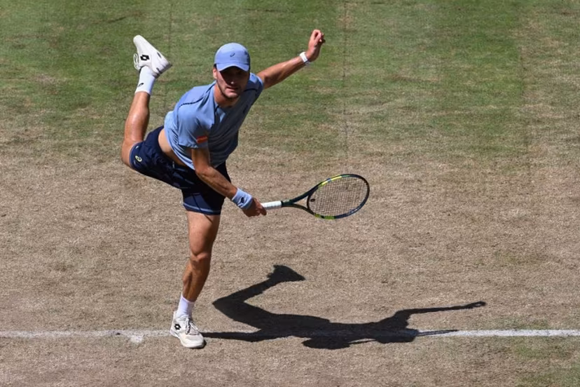 Belgium's Raphael Collignon returns the ball to Germany's Alexander Zverev during their men's singles quarter-final match of the Halle Open ATP tennis tournament in Halle, western Germany, on June 19, 2026. CARMEN JASPERSEN / AFP