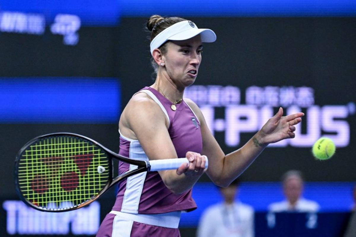 Belgium's Elise Martens hits a return to China's Zheng Qinwen during their women's singles semi-final at the China Open tennis tournament in Beijing on October 10, 2026. Adek BERRY / AFP