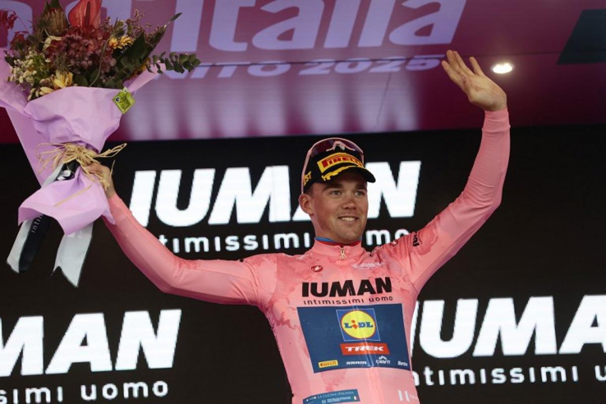Overall leader Lidl-Trek's Danish rider Mads Pedersen celebrates on the podium of the 6th stage of the 108th Giro d'Italia cycling race 227kms from Potenza to Naples on May 15, 2025. Luca Bettini / AFP