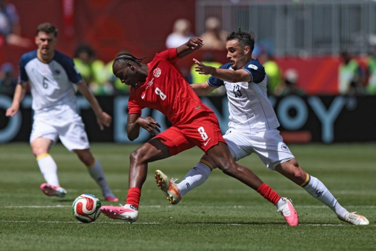Canada's midfielder #08 Ismael Kone (C) fights for the ball with Bosnia-Herzegovina's midfielder #13 Ivan Basic during the 2026 World Cup Group B football match between Canada and Bosnia and Herzegovina at the Toronto Stadium in Toronto on June 12, 2026. Cole Burston / AFP
