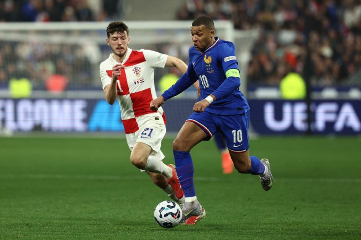 France's forward #10 Kylian Mbappe (R) and Croatia's midfielder #21 Petar Sucic (L) fight for the ball during the UEFA Nations League quarter-final second-leg football match between France and Croatia at the Stade de France in Saint-Denis, north of Paris, on March 23, 2025. FRANCK FIFE / AFP