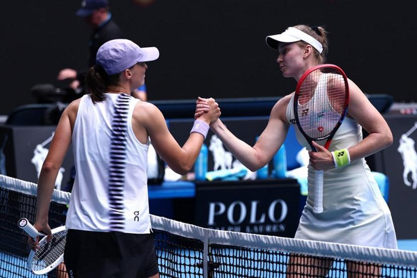 Kazakhstan's Elena Rybakina (R) shakes hands with Poland's Iga Swiatek after their women's singles quarter-final match on day eleven of the Australian Open tennis tournament in Melbourne on January 28, 2026. IZHAR KHAN / AFP