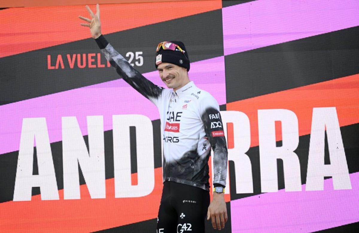 Team UAE's Australian rider Jay Vine celebrates on the podium after winning the sixth stage of La Vuelta a Espana cycling tour, a 170 km race between Olot and Pal, in Andorra, on August 28, 2025. Josep LAGO / AFP