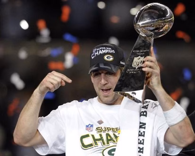 Green Bay Packers quarterback Aaron Rodgers celebrates with the trophy after the Packers defeated the Pittsburgh Steelers 31-25 in the NFL Super Bowl XLV football game at Cowboys Stadium on February 6, 2011 in Arlington, Texas. AFP PHOTO / TIMOTHY A. CLARY