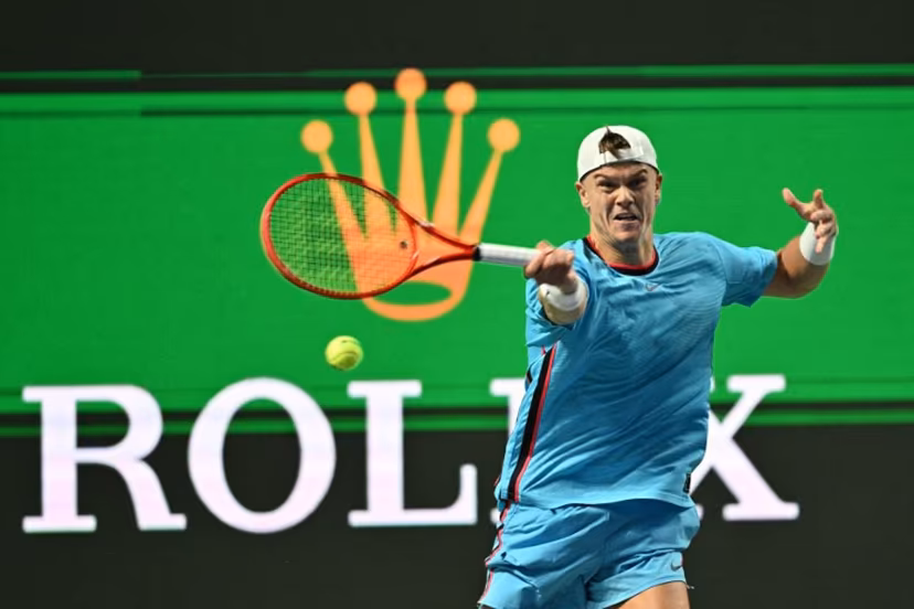 Denmark's Holger Rune hits a return to Germany's Daniel Altmaier during their men's singles match at the Shanghai Masters tennis tournament in Shanghai on October 7, 2026. Hector RETAMAL / AFP