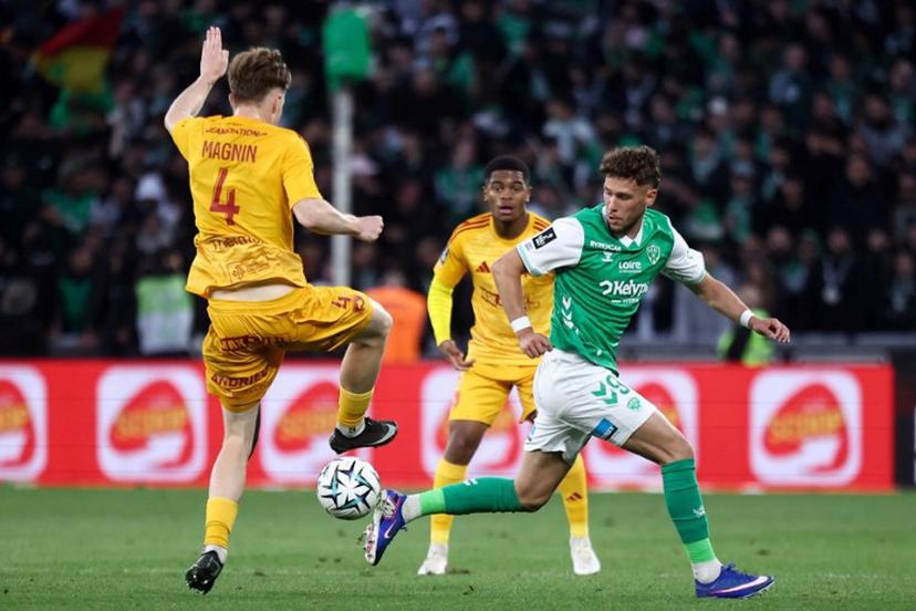 Rodez's Swiss defender #04 Mathis Magnin (L) fights for the ball with Saint-Etienne's Belgian forward #09 Lucas Stassin (R) during the French L1-L2 playoff second leg football match between AS Saint-Etienne and Rodez at the stade Geoffroy Guichard in Saint-Etienne, south-eastern France on May 15, 2026. Alex MARTIN / AFP