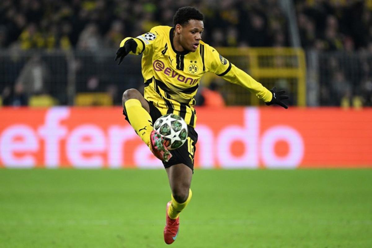 Dortmund's Belgian forward #16 Julien Duranville controls the ball during the UEFA Champions League second-leg knockout round play-off football match BVB Borussia Dortmund vs Sporting CP at the Signal Iduna stadium in Dortmund, western Germany, on February 19, 2025. UWE KRAFT / AFP