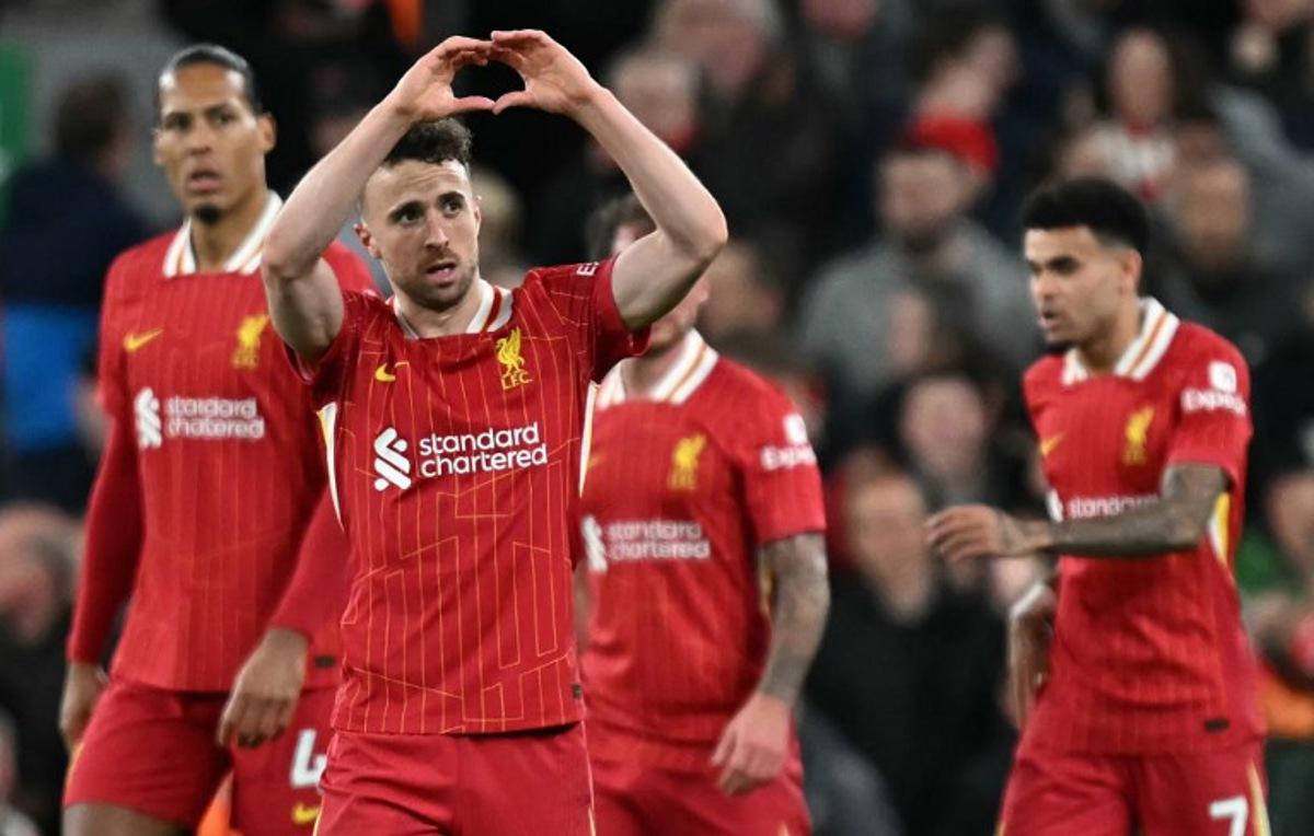 Liverpool's Portuguese striker #20 Diogo Jota (2L) celebrates scoring the opening goal during the English Premier League football match between Liverpool and Everton at Anfield in Liverpool, north west England on April 2, 2025. Paul ELLIS / AFP