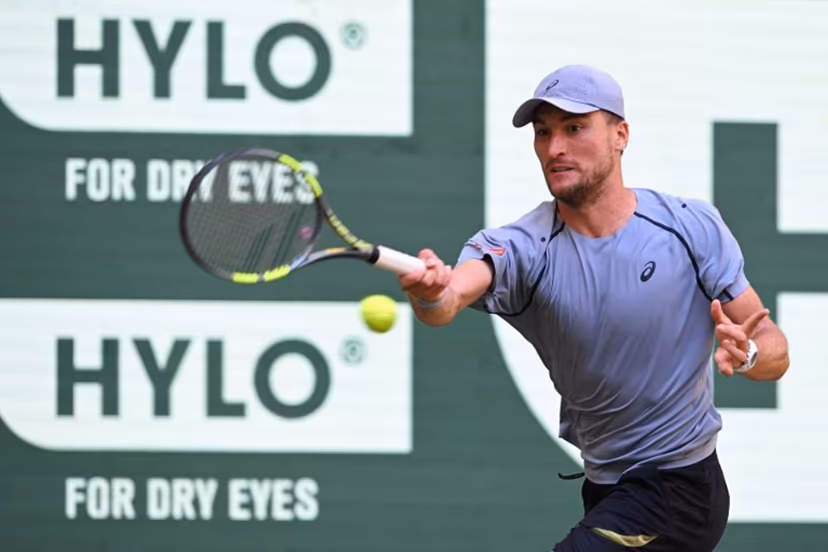 Belgium's Raphael Collignon returns the ball to Germany's Alexander Zverev during their men's singles quarter-final match of the Halle Open ATP tennis tournament in Halle, western Germany, on June 19, 2026. CARMEN JASPERSEN / AFP