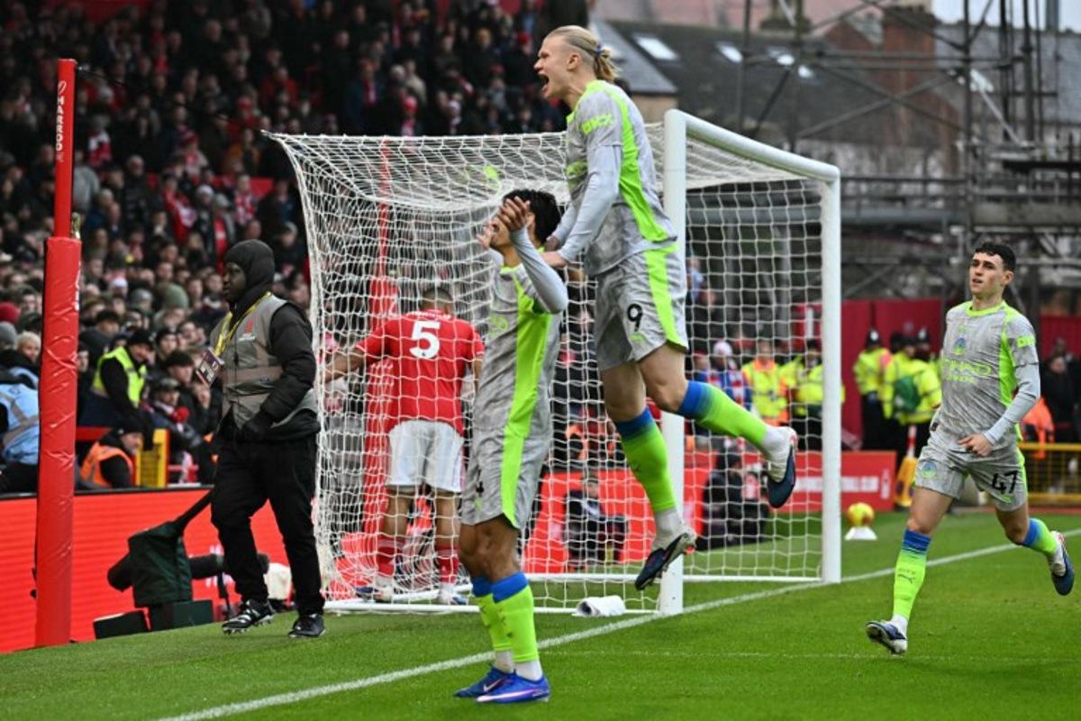 Manchester City's Dutch midfielder #04 Tijjani Reijnders (L) celebrates with teammates after scoring the opening goal of the English Premier League football match between Nottingham Forest and Manchester City at The City Ground in Nottingham, central England, on December 27, 2025. Ben STANSALL / AFP