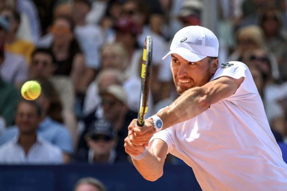 Belgium's Raphael Collignon returns the ball to Greece's Stefanos Tsitsipas during their men's singles final match at the Swiss Open tennis tournament in Gstaad, on July 19, 2026. Fabrice COFFRINI / AFP