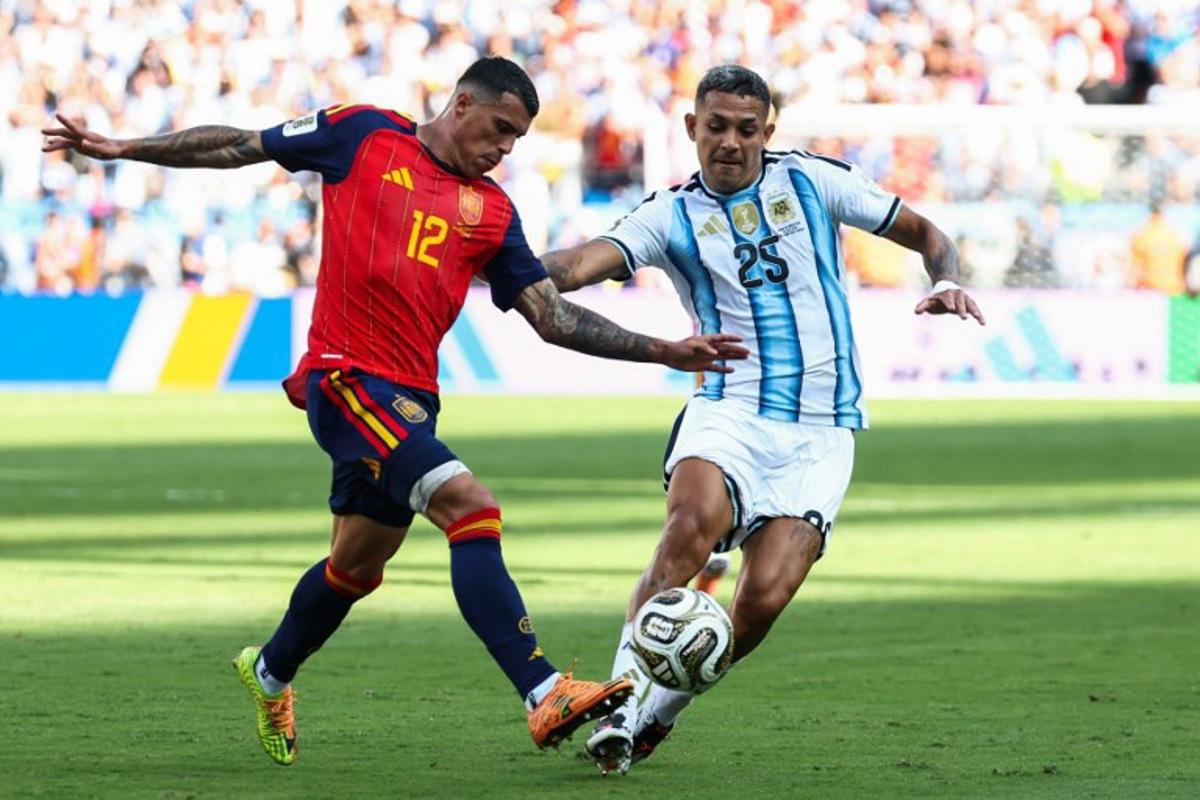 Spain's defender #12 Pedro Porro and Argentina's defender #25 Facundo Medina fight for the ball during the 2026 World Cup football tournament final match between Spain and Argentina at the New York/New Jersey Stadium in East Rutherford on July 19, 2026. FRANCK FIFE / AFP