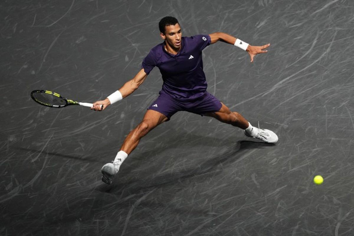 Canada's Felix Auger-Aliassime plays a forehand return to Italy's Jannik Sinner during their men's singles final match on day seven of the Paris ATP Masters 1000 tennis tournament at the Paris La Défense Arena in Nanterre, on the outskirts of Paris, on November 2, 2025. Dimitar DILKOFF / AFP