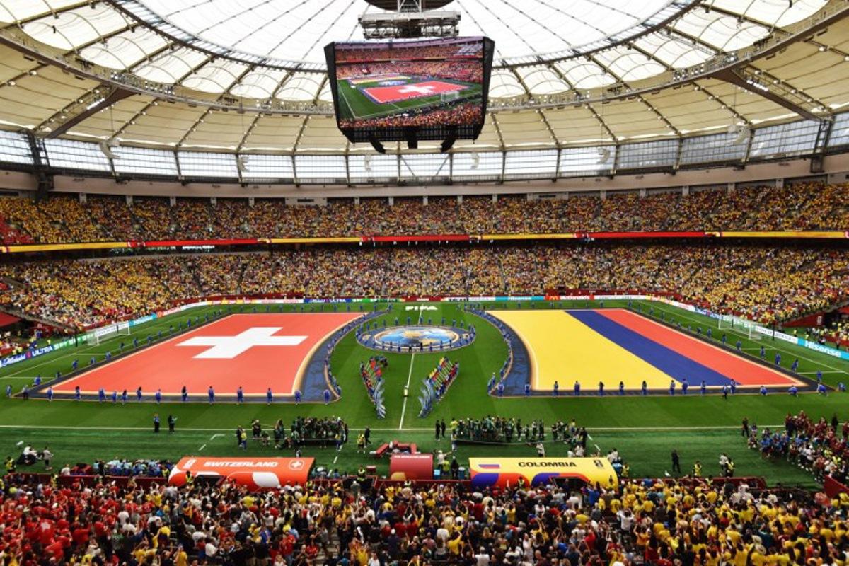 The flags of Switzerland and Colombia are displayed on the pitch ahead of their 2026 World Cup round of 16 football match at Vancouver Stadium in Vancouver on July 7, 2026. Don MacKinnon / AFP