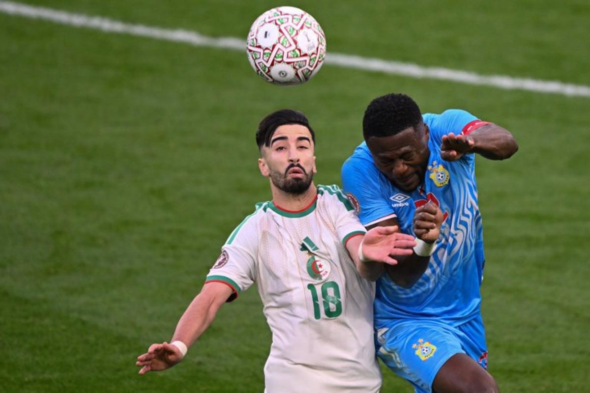 Algeria's forward #18 Mohamed Amoura and Democratic Republic Of Congo's defender #22 Chancel Mbemba jump for the ball during the Africa Cup of Nations (CAN) round of 16 football match between Algeria and Democratic Republic of Congo at the Prince Moulay El Hassan Stadium in Rabat on January 6, 2026. SEBASTIEN BOZON / AFP