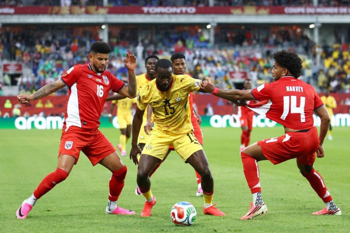 Panama's defender #16 Andres Andrade, Ghana's midfielder #15 Elisha Owusu and Panama's midfielder #14 Carlos Harvey fight for the ball during the 2026 World Cup Group L football match between Ghana and Panama at the Toronto Stadium in Toronto on June 17, 2026. Cole Burston / AFP