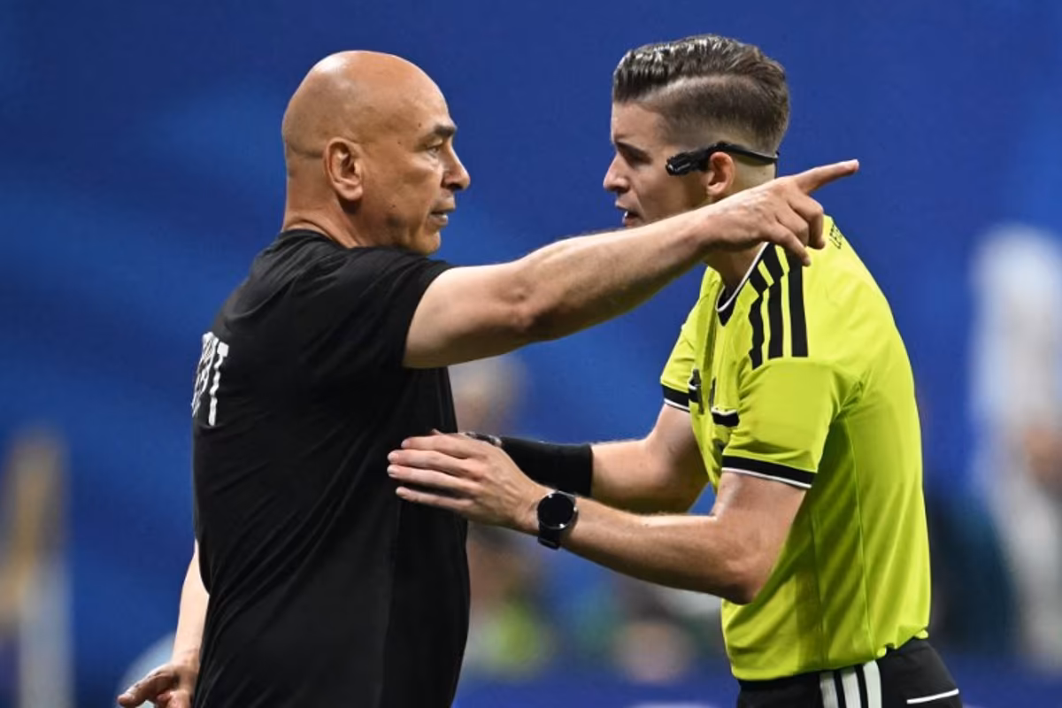 Egypt's head coach Hossam Hassan speaks with French referee Francois Letexier during the 2026 World Cup round of 16 football match between Argentina and Egypt at Atlanta Stadium in Atlanta on July 7, 2026. ROBERTO SCHMIDT / AFP