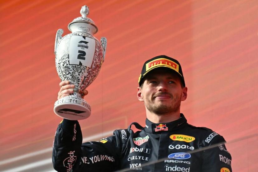 Second placed Red Bull Racing's Dutch driver Max Verstappen celebrates with the trophy on the podium after the Formula One Hungarian Grand Prix at the Hungaroring racetrack in Mogyorod near Budapest, Hungary, on July 26, 2026. Andrej ISAKOVIC / AFP