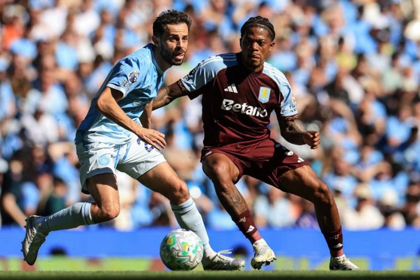 Aston Villa's Jamaican midfielder #31 Leon Bailey (R) challenges Manchester City's Portuguese midfielder #20 Bernardo Silva (L) during the English Premier League football match between Manchester City and Aston Villa at the Etihad Stadium in Manchester, north west England, on May 24, 2026. Darren Staples / AFP