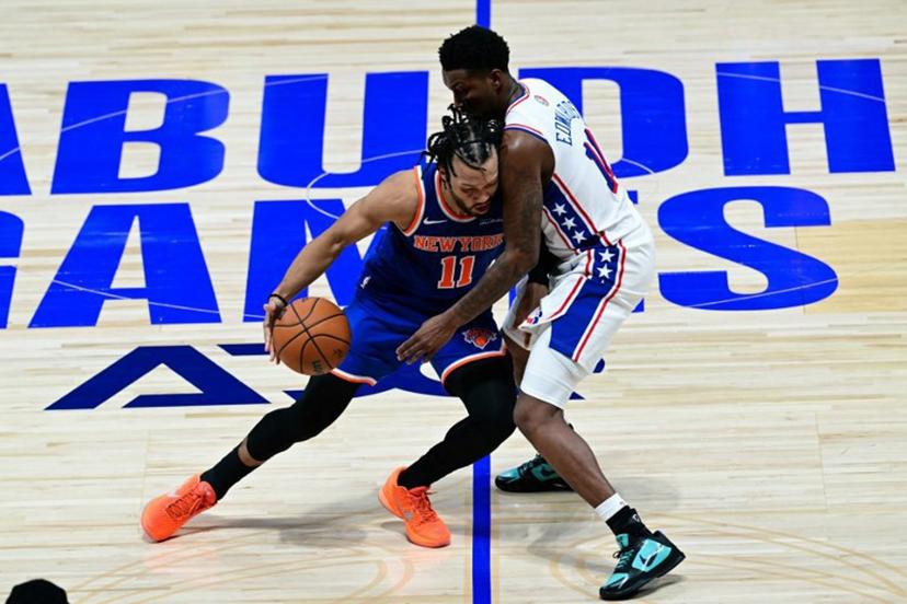 New York Knicks' #11 Jalen Brunson dribbles against Philadelphia 76ers' #11 Justin Edwards during the NBA basketball game between the New York Knicks and the Philadelphia 76ers at the Etihad Arena in Abu Dhabi on October 2, 2025. Giuseppe CACACE / AFP