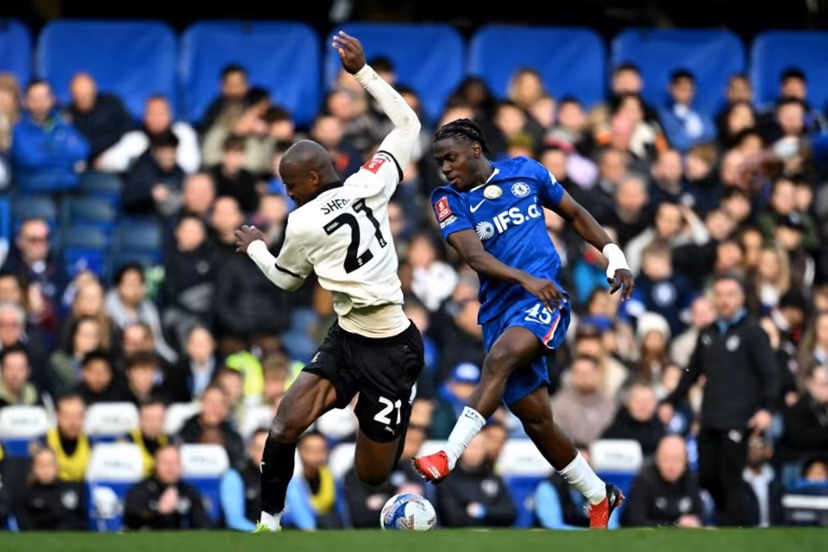 Chelsea's Belgian midfielder #45 Romeo Lavia battles for the ball with Port Vale's Liberian forward #21 Martin Sherif during the English FA Cup quarter final football match between Chelsea and Port Vale at Stamford Bridge in London on April 4, 2026. Ben STANSALL / AFP