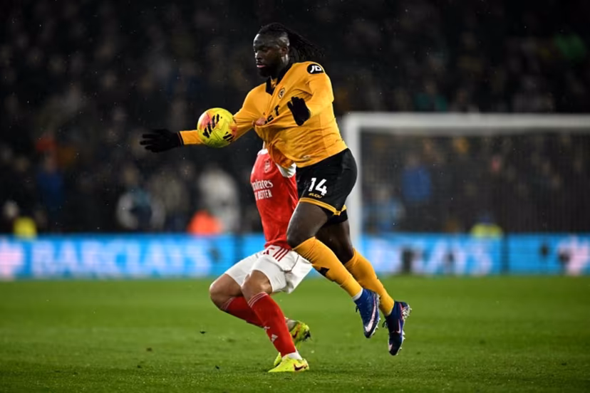 Arsenal's French defender #02 William Saliba pulls the shirt of Wolverhampton Wanderers' Nigerian striker #14 Tolu Arokodare during the English Premier League football match between Wolverhampton Wanderers and Arsenal at the Molineux stadium in Wolverhampton, central England on February 18, 2026. Paul ELLIS / AFP