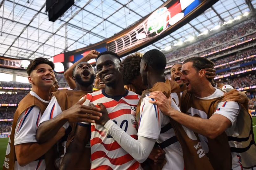 US forward #20 Folarin Balogun (c) celebrates with teammates after scoring his team's third goal during the 2026 World Cup Group D football match between USA and Paraguay at the Los Angeles Stadium in Inglewood on June 12, 2026. Patrick T. Fallon / AFP