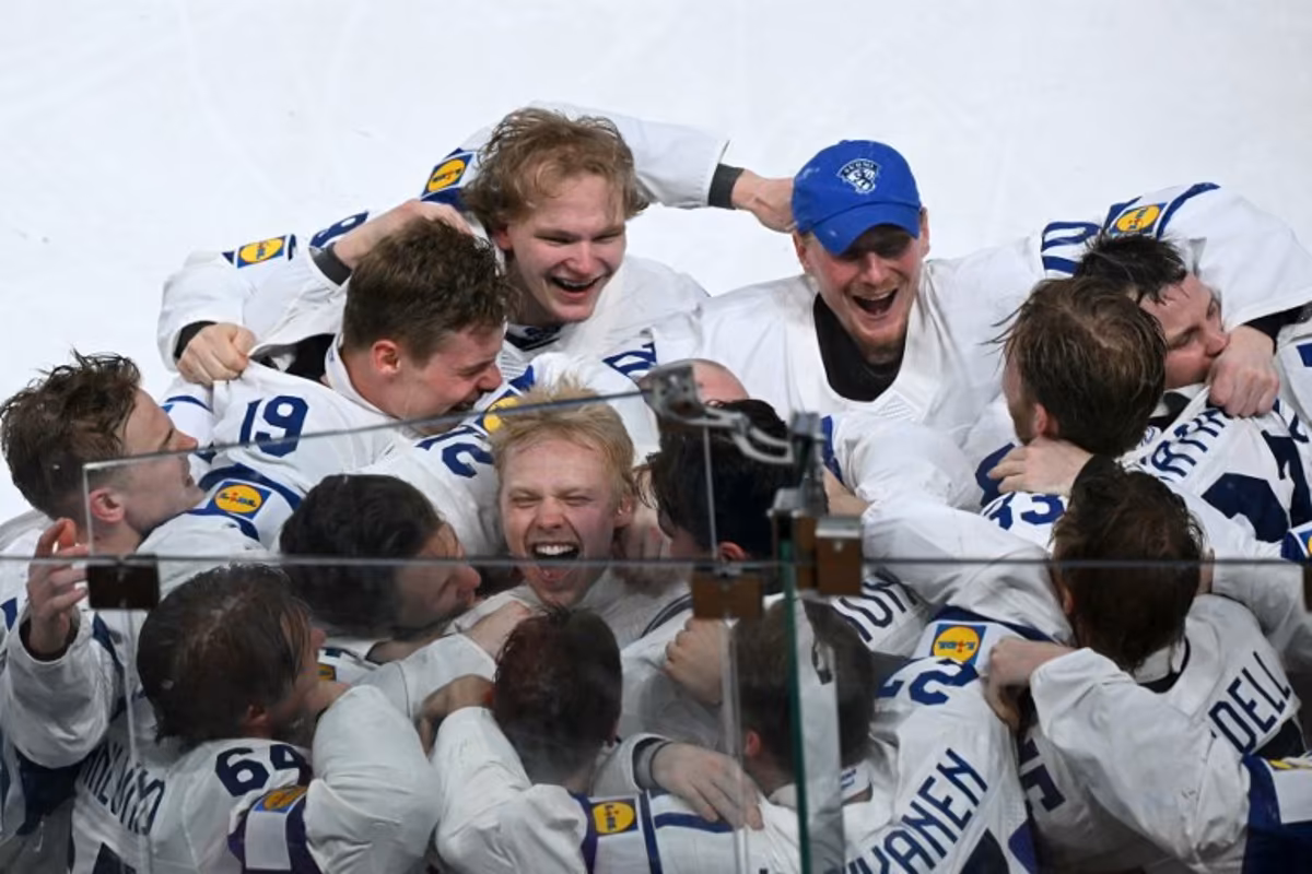 Finland's forward #94 Konsta Helenius (C) celebrates with teammates after scoring the sudden-death goal to win during the over time of the IIHF Ice Hockey Men's World Championship final match between Switzerland and Finland at the Swiss Life Arena in Zurich on May 31, 2026. SEBASTIEN BOZON / AFP