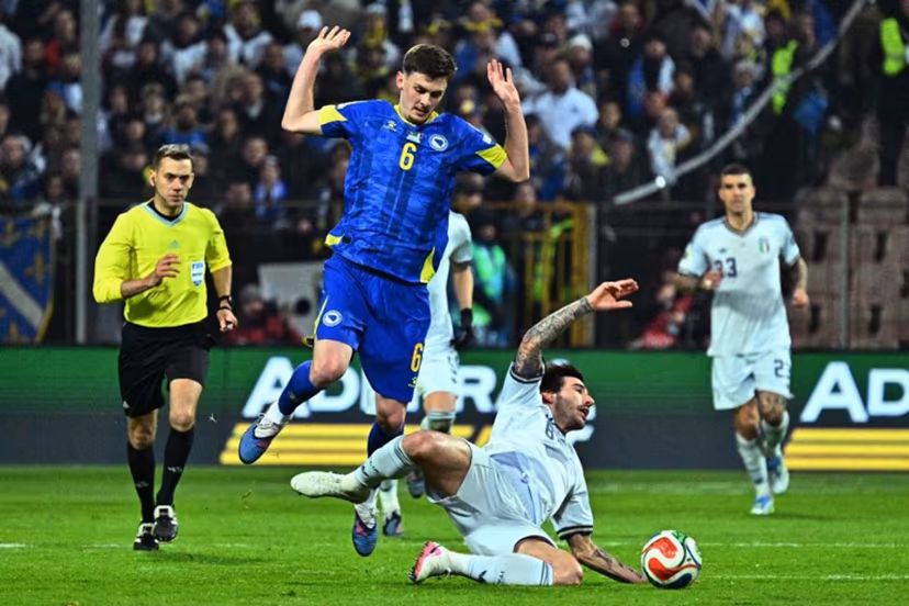 Bosnia-Herzegovina's midfielder #06 Benjamin Tahirovic (L) fights for the ball with Italy's midfielder #08 Sandro Tonali during the FIFA World Cup 2026 European qualification final football match between Bosnia-Herzegovina and Italy at the Bilino-Polje stadium in Zenica on March 31, 2026. Elvis BARUKCIC / AFP