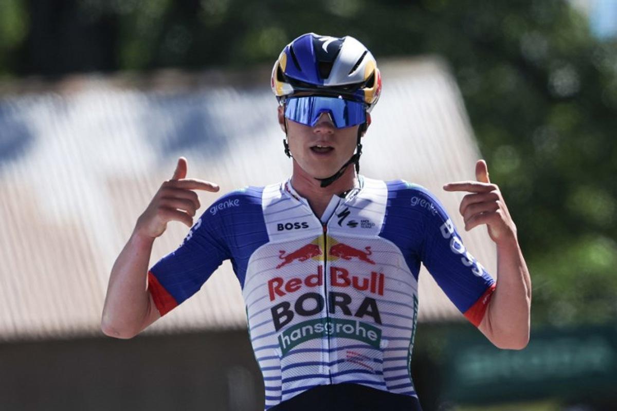Red Bull - Bora - Hansgrohe's Belgian rider Maxim Van Gils celebrates as he cycles across the finish line to win the 6th stage of the Tour Auvergne-Rhone-Alpes cycling race (formerly known as the Criterium du Dauphine), 182,3km between Saint-Vulbas and Crest-Voland in the French Alps on June 12, 2026. Anne-Christine POUJOULAT / AFP